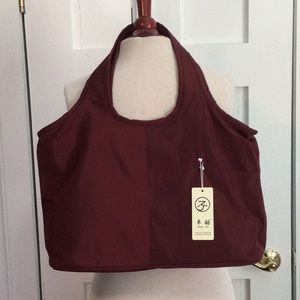 Dark red purse with multiple zippers and pockets